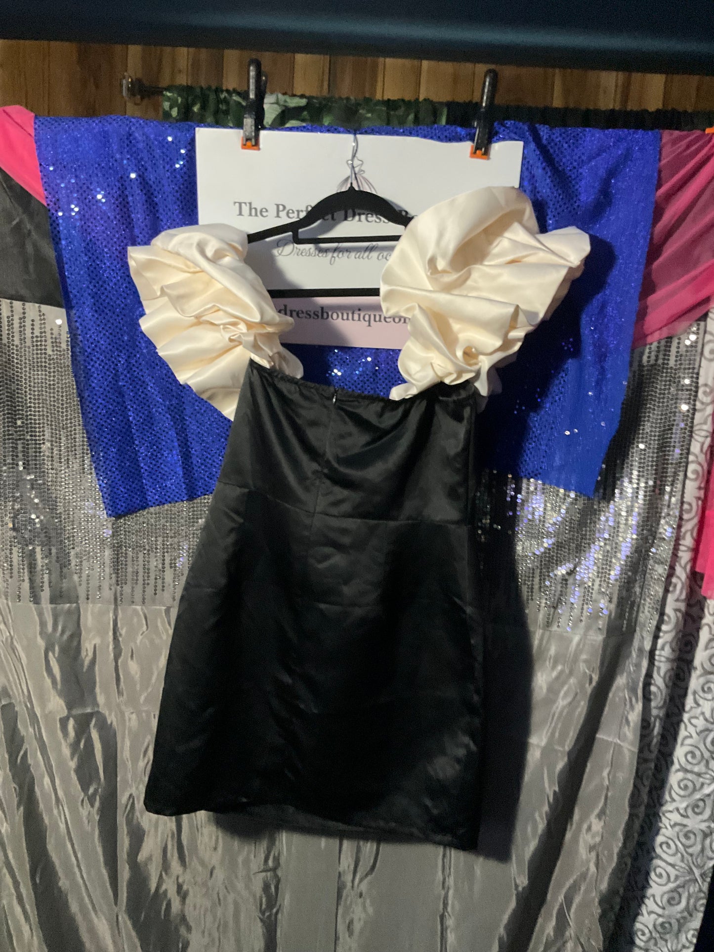 Black satin dress with white ruffles